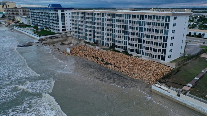 In this aerial view, a seawall along a condo building is shown breached by Hurricane Nicole on November 10, 2022 in Daytona Beach, Florida. 