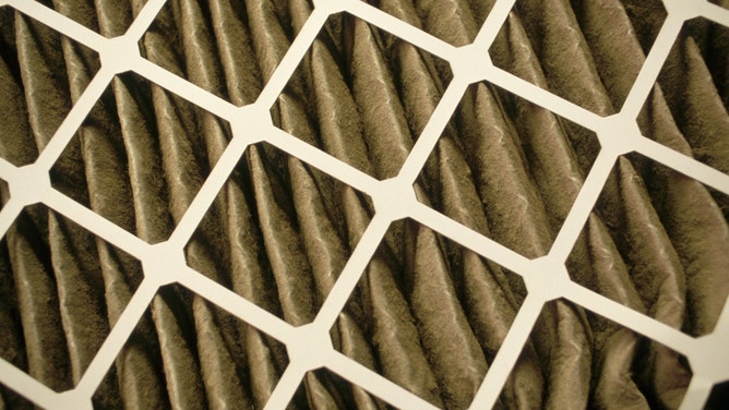 A close up view of an air filter that has been newly installed into an air handling system.