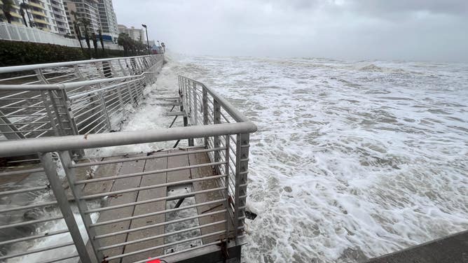 Waves crash over the Daytona Beach boardwalk as Tropical Storm Nicole continues to move northwest across Florida on Nov. 10, 2022.