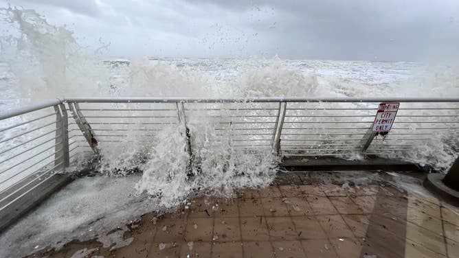 Waves crash over the Daytona Beach boardwalk as Tropical Storm Nicole continues to move northwest across Florida on Nov. 10, 2022.