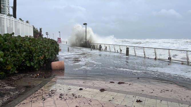 Waves crash over the Daytona Beach boardwalk as Tropical Storm Nicole continues to move northwest across Florida on Nov. 10, 2022.