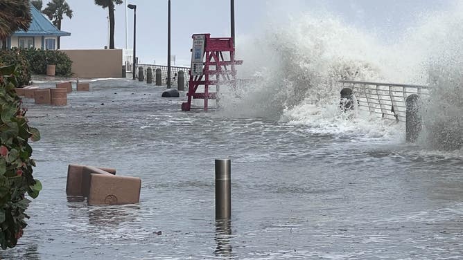 Waves crash over the Daytona Beach boardwalk as Tropical Storm Nicole continues to move northwest across Florida on Nov. 10, 2022.
