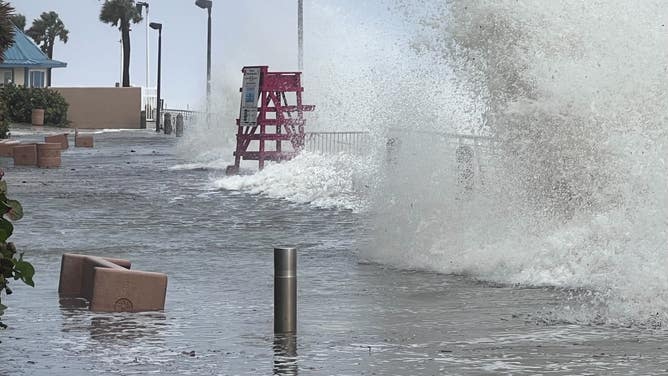 Waves crash over the Daytona Beach boardwalk as Tropical Storm Nicole continues to move northwest across Florida on Nov. 10, 2022.