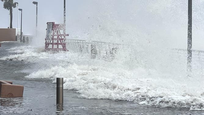 Waves crash over the Daytona Beach boardwalk as Tropical Storm Nicole continues to move northwest across Florida on Nov. 10, 2022.