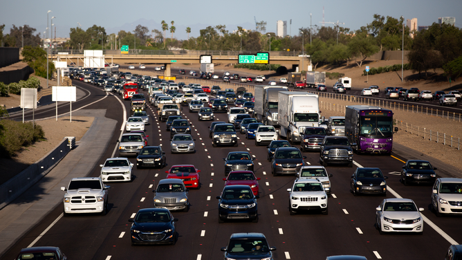 FILE - Vehicles travel on Interstate 10 during rush hour in Phoenix, Arizona, U.S., on Thursday, April 22, 2021.