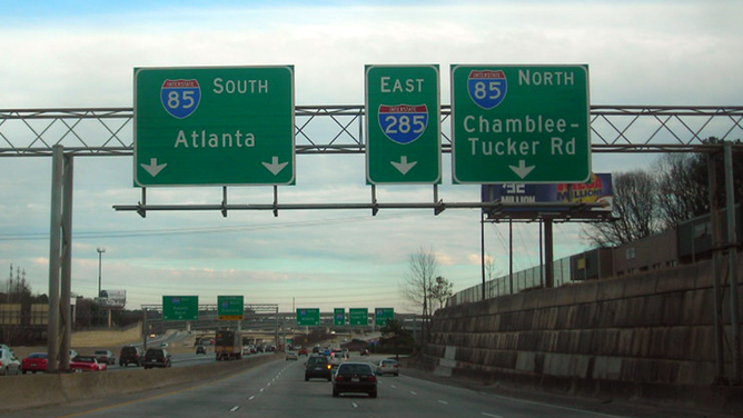 FILE - Highway signs showing I-285 in Georgia.