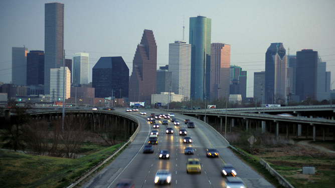 FILE - Texas, Houston, Skyline At Dusk And I-45 Commuter Traffic.