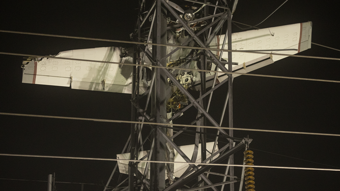 MARYLAND, UNITED STATES - NOVEMBER 28: A small plane is seen after it crashed into a power line tower in Maryland, United States on November 28, 2022. Search and rescued workers and firefighters rescue two people.