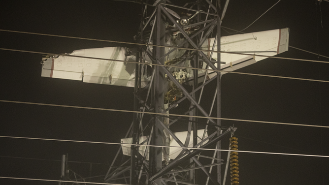 MARYLAND, UNITED STATES - NOVEMBER 28: A small plane is seen after it crashed into a power line tower in Maryland, United States on November 28, 2022. Search and rescued workers and firefighters rescue two people.