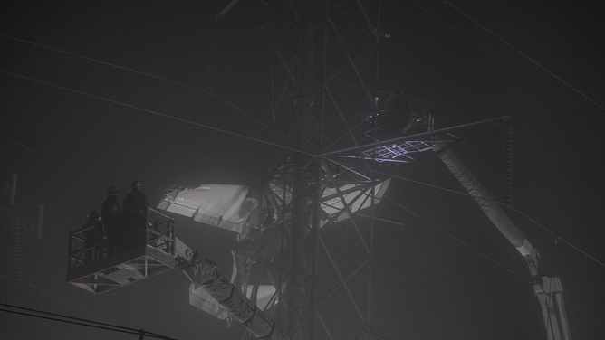MARYLAND, UNITED STATES - NOVEMBER 28: Search and rescue workers and firefighters conduct operation after a small plane crashed into Transmission Tower in Maryland, United States on November 28, 2022. The crash caused widespread power outages in Montgomery County.