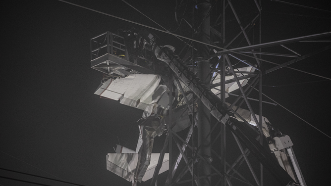 MARYLAND, UNITED STATES - NOVEMBER 28: Search and rescue workers and firefighters rescue two people after a small plane crashed into a power line tower in Maryland, United States on November 28, 2022.