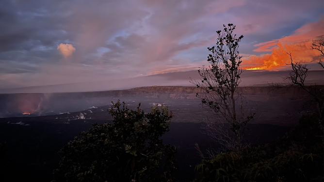 Lava from Kīlauea volcano lava lake is seen to the left of the photo, and a magnificent glow from Mauna Loa, upper right, sets the morning sky aglow.