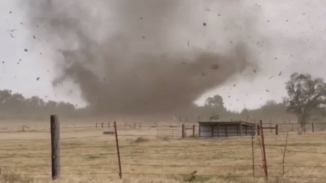 A tornado hits the ground and causes debris to fly in Miller Grove, Texas.