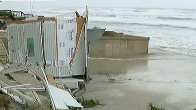 Part of a home that has fallen into the sea.