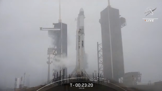 A SpaceX Falcon 9 on Kennedy Space Center launchpad 39A in the rain ahead of a launch attempt on Nov. 22, 2022.