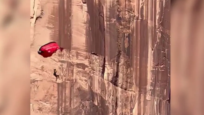 A screenshot taken from a video recorded by hikers near Moab, Utah, shows the jumper’s parachute catching a gust of wind, before slamming into a 400-foot cliff.