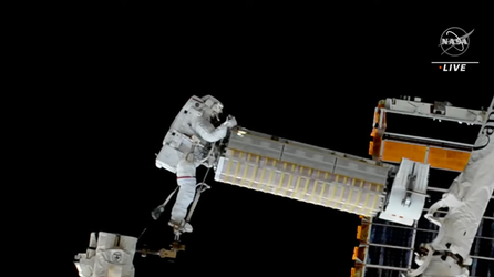 Spacewalking astronauts install solar arrays outside International Space Station