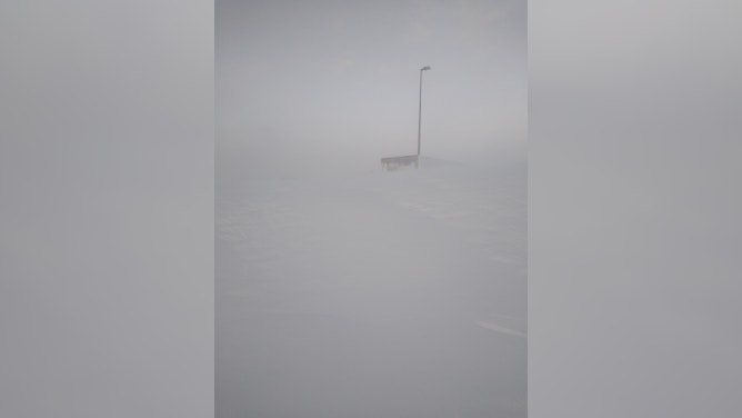 Semi trucks were buried during a blizzard in South Dakota forcing their drivers to stay at a fuel stop for days. (Image credit: TIM PLETTEN)