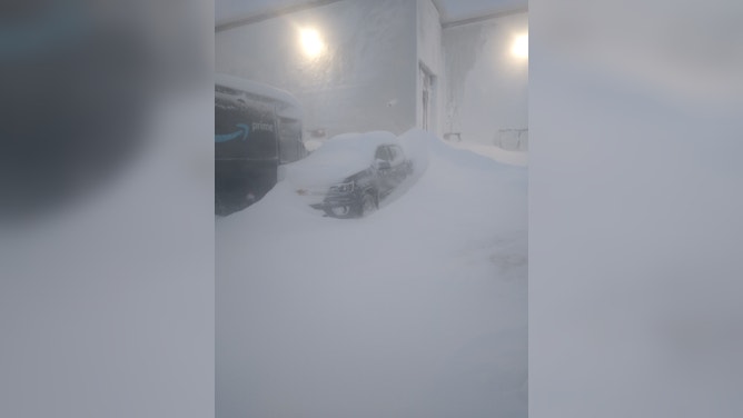 Semi trucks were buried during a blizzard in South Dakota forcing their drivers to stay at a fuel stop for days. (Image credit: TIM PLETTEN)