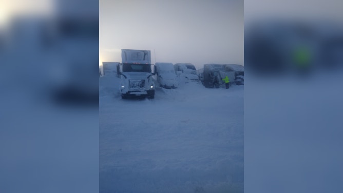 Semi trucks were buried during a blizzard in South Dakota forcing their drivers to stay at a fuel stop for days. (Image credit: TIM PLETTEN)