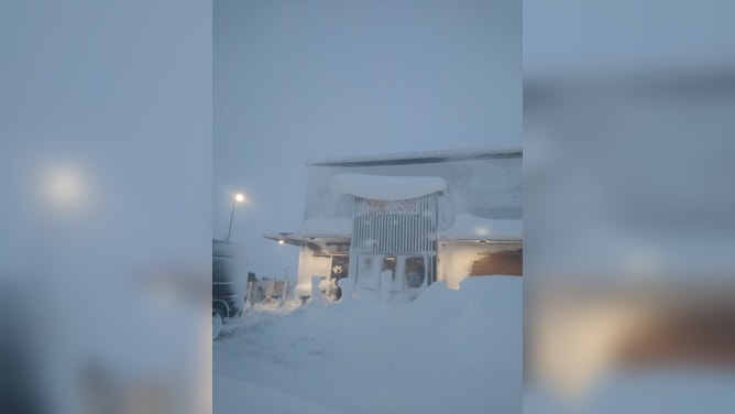 Semi trucks were buried during a blizzard in South Dakota forcing their drivers to stay at a fuel stop for days. (Image credit: TIM PLETTEN)