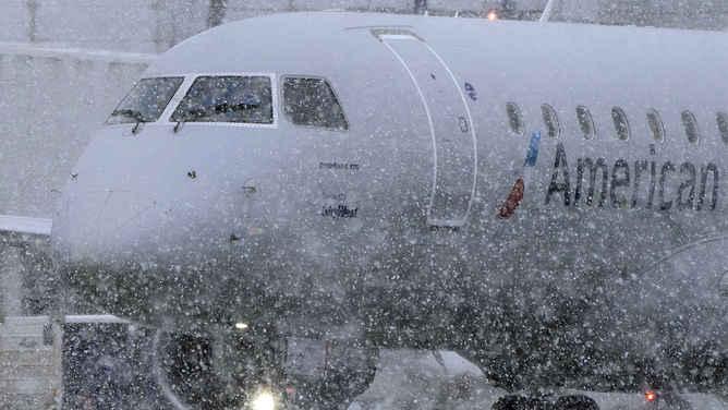FILE - An American Eagle plane taxis during a snow storm at Seattle-Tacoma International Airport (SEA) in Seattle, Washington, US, on Tuesday, Dec. 20, 2022.