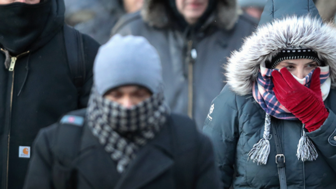 FILE - Commuters make their way to work in sub-zero temperatures.