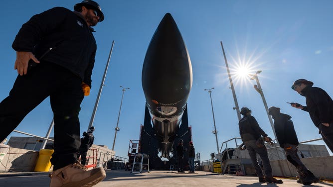 Rocket Lab teams work to prepare the Electron rocket to liftoff on Dec. 16 from Wallops, Virginia.