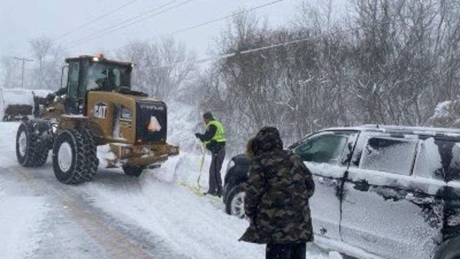 Troopers assist stranded motorists in Genesee County in western New York on December 24, 2022.