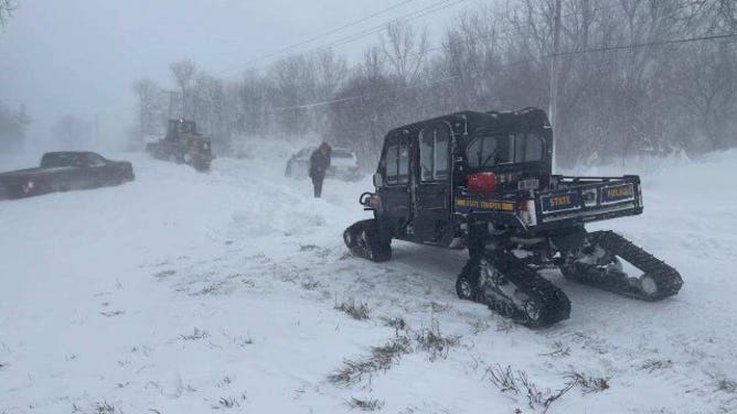 Troopers assist stranded motorists in Genesee County in New York on December 24, 2022.