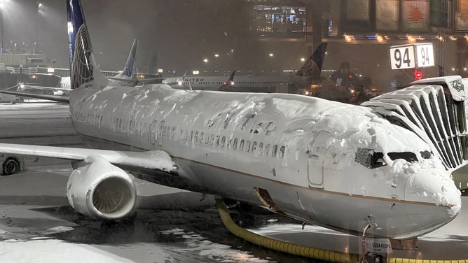 FILE - A United Airlines plane is seen as runway covered with snow at Newark Liberty International Airport on January 7, 2022 in New Jersey.