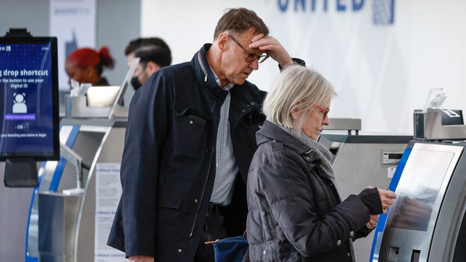 FILE - Travelers check in for their flight at O'Hare International Airport in Chicago, Illinois, on November 22, 2022.