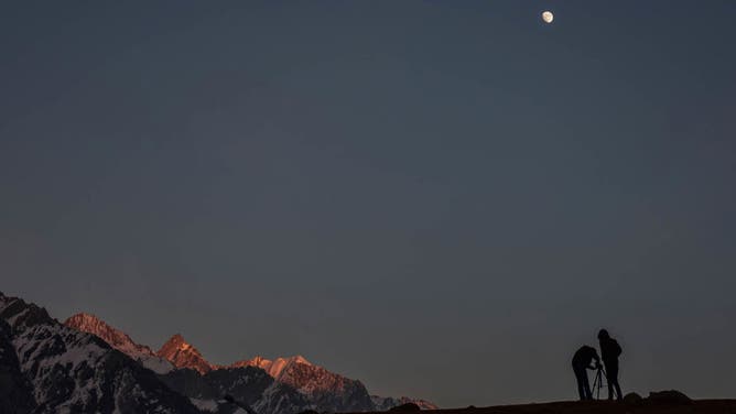 Photographers set up their tripod to take pictures on a cold winter evening in Sonamarg, some 100 km northeast of Srinagar, the summer capital of Jammu and Kashmir.