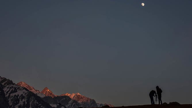 Photographers set their tripod to take pictures during a cold winter evening in Sonamarg, about 100kms northeast of Srinagar, the summer capital of Jammu and Kashmir.