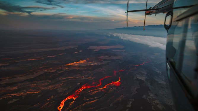 In an aerial view, lava fissures flow downslope from the north flank of Mauna Loa Volcano on December 7, 2022 in Hilo, Hawaii.