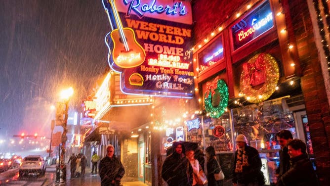 Snow falls on Broadway, a popular tourist destination in Nashville, Tennessee, on December 22, 2022.