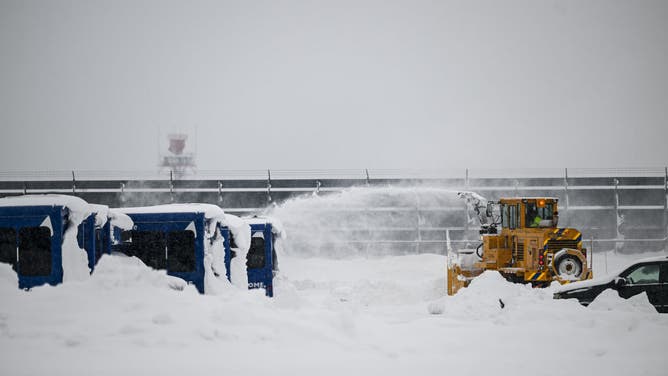 Crew members scramble to clear the runway at Buffalo Niagara International Airport in Buffalo, New York, USA, December 27, 2022.