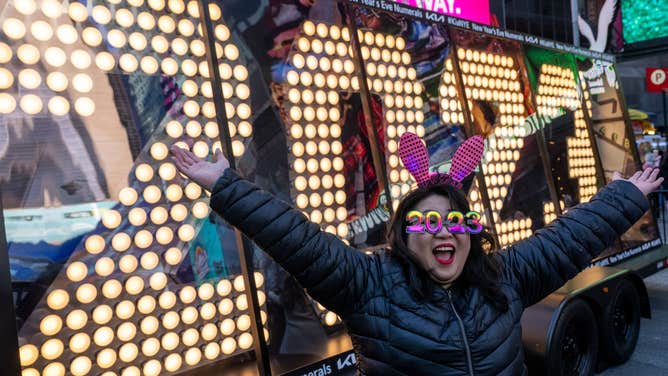 Teresa Hui, wearing 2023 glasses, poses in front of the 