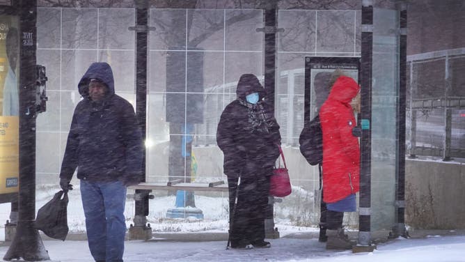 Commuters wait for a bus as temperatures drop into the single digits on December 22, 2022 in Chicago, Illinois. A winter weather system bringing snow, high winds and freezing temperatures wreaked havoc on much of the county ahead of the holidays. It is expected to become
