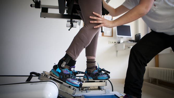 At a clinic specializing in rehabilitation after a stroke of head injury, a patient undergoes rehabilitation.