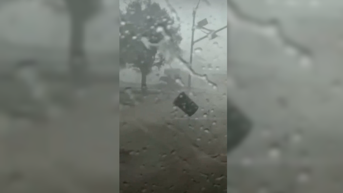 A garbage can flies through the air during a storm in Grapevine, TX on December 13, 2022.