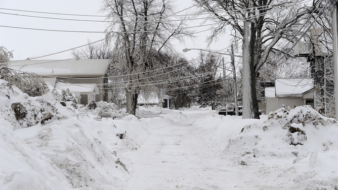HAMBURG, NY - DECEMBER 27: Mid Shore drive is covered with ice after being battered with waves from Lake Erie along Hoover Beach on December 27, 2022 in Hamburg, New York. The historic winter storm Elliott dumped up to four feet of snow on the area leaving thousands without power and twenty eight confirmed dead in the city of Buffalo and the surrounding suburbs.