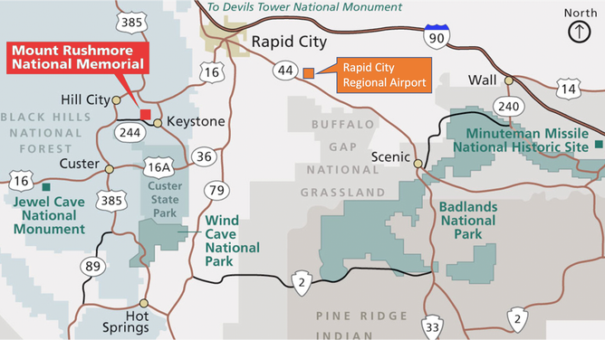 Road map of area around Mount Rushmore National Memorial. A red box marks the location of the park, and an orange box marks the location of the nearby airport. Interstate-90 traces along the top of the map.