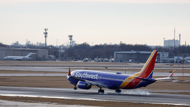 A Southwest Airlines passenger jet lands at Chicago Midway International Airport in Chicago, Illinois, on December 28, 2022. - The perfect storm of fierce snow squalls, howling wind and sub-zero temperatures forced the cancellation of thousands of flights in recent days, including around 5,900 on Tuesday and Wednesday, according to tracking site FlightAware.com. Most of the cancellations on December 27-28 were at Southwest Airlines, which pulled more than 60 percent of its flights due to cascading logistics issues.