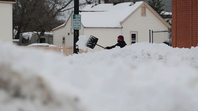 Man shoveling snow in Buffalo