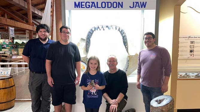 Molly with paleontologists at the Calvert Marine Museum, which has an exhibit dedicated to prehistoric finds.