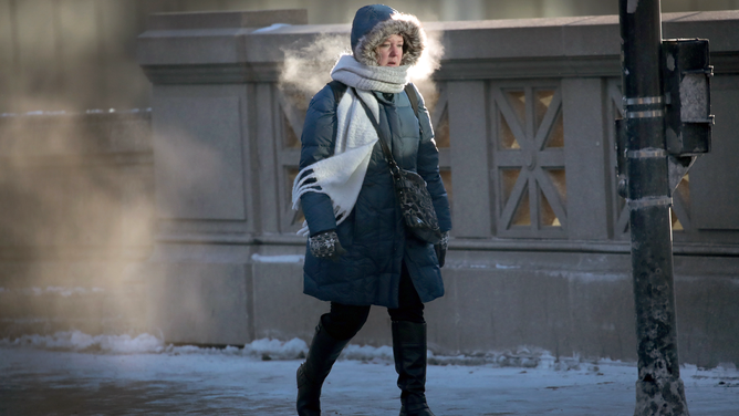 FILE - A commuter makes her way to work in sub-zero temperatures on January 2, 2018 in Chicago, Illinois.