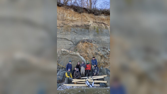 A photo of the early members of the field crew. Notice that the whale skull is wrapped in fabric, through the handles of which are 2x4’s that we used to lift the 650 pound skull into a pontoon boat. From left to right: Chris Storck (back), Cody Goddard (below him - front), John Bennett, Kevin Schmidt, Rebecca Benton, Dr. Victor Perez, Dr. Geoff Bowers, Stephen Groff, and David Hoppe.