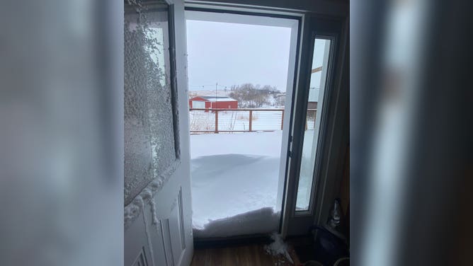 Snow in Climbing Hill, Iowa. Note the rectangular impression the door made into the snowpack. January 19, 2023.