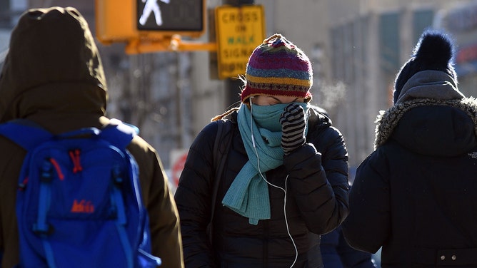 People walk through the freezing cold in the Brooklyn borough of New York on January 31, 2019.